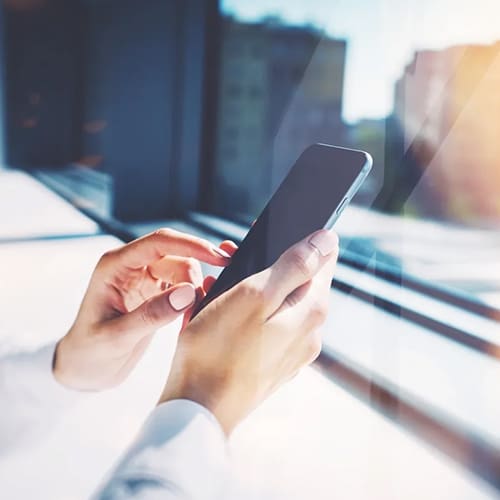 A person is holding their cell phone in his hand.